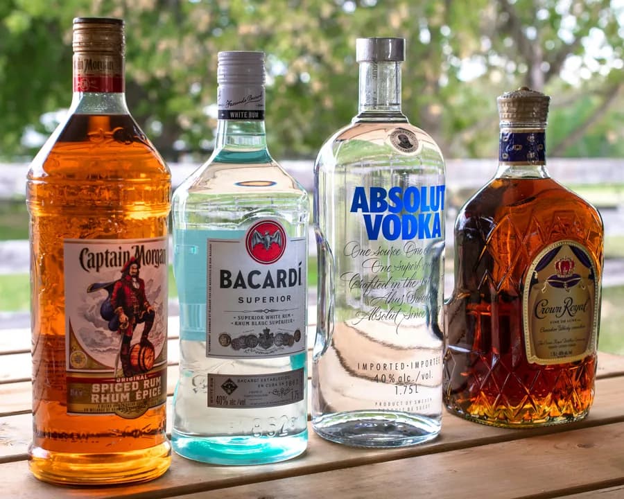 Captain Morgan, Bacardi, Absolut Vodka, and Crown Royal bottles lined up