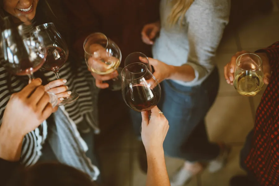 Friends clinking wine glasses together at a gathering