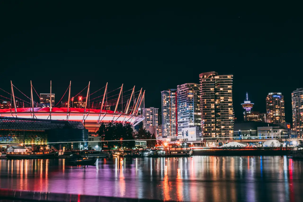BC Place and Vancouver skyline lit up at night